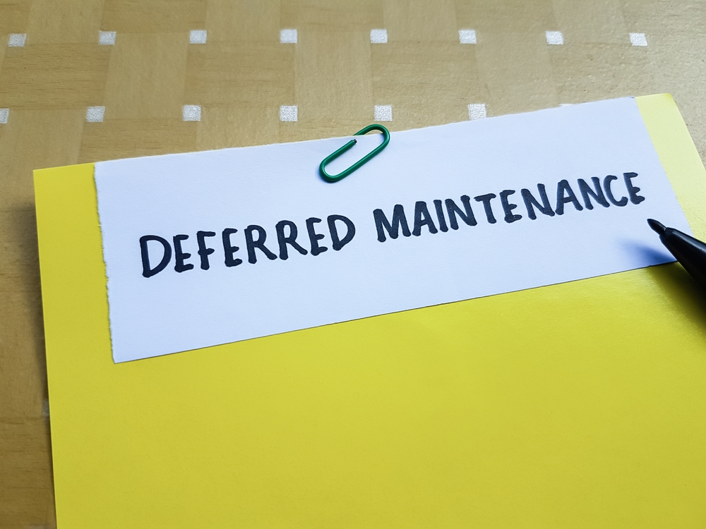 Deferred,maintenance,writting,on,table,background.